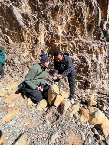 Magasinet 4-2025. Har en snö- leopard passerat? Louise och viltvårdaren A Cheng kontrollerar en kamera- fälla i Quinlinbergen i nordöstra Kina.